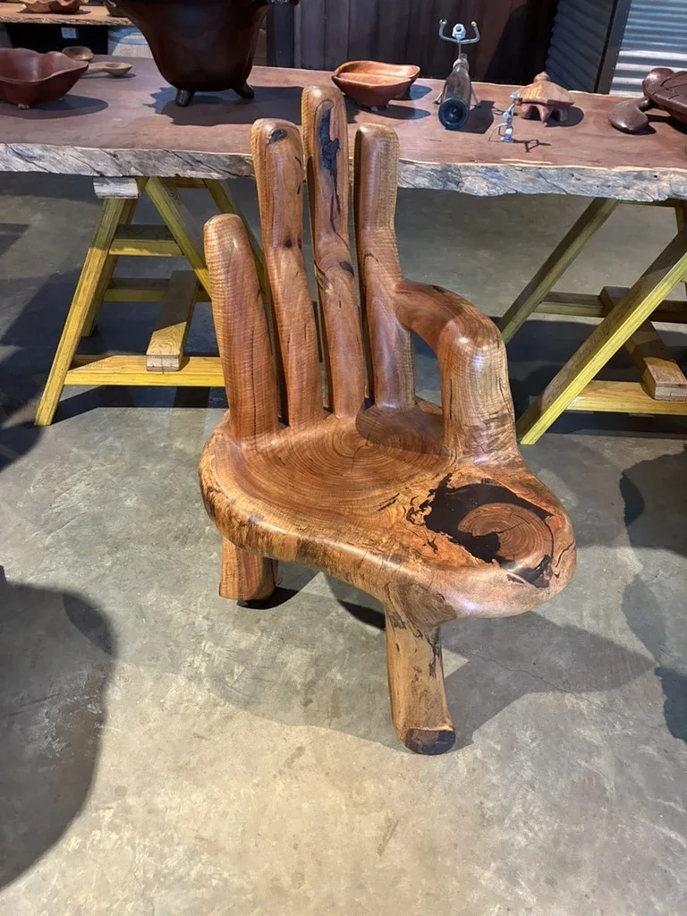 Complete handmade timber chair with natural-edge arms and carved back