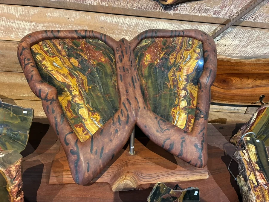 Butterfly-shaped timber chair with colorful inset panels