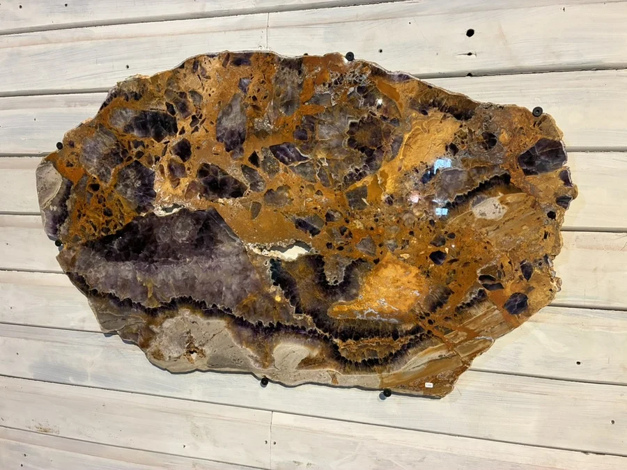Polished mineral platter with amber and charcoal markings