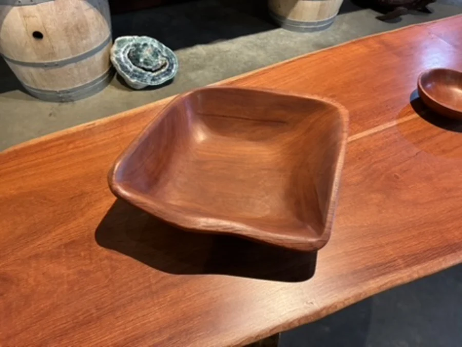 Square carved timber bowl on a polished table